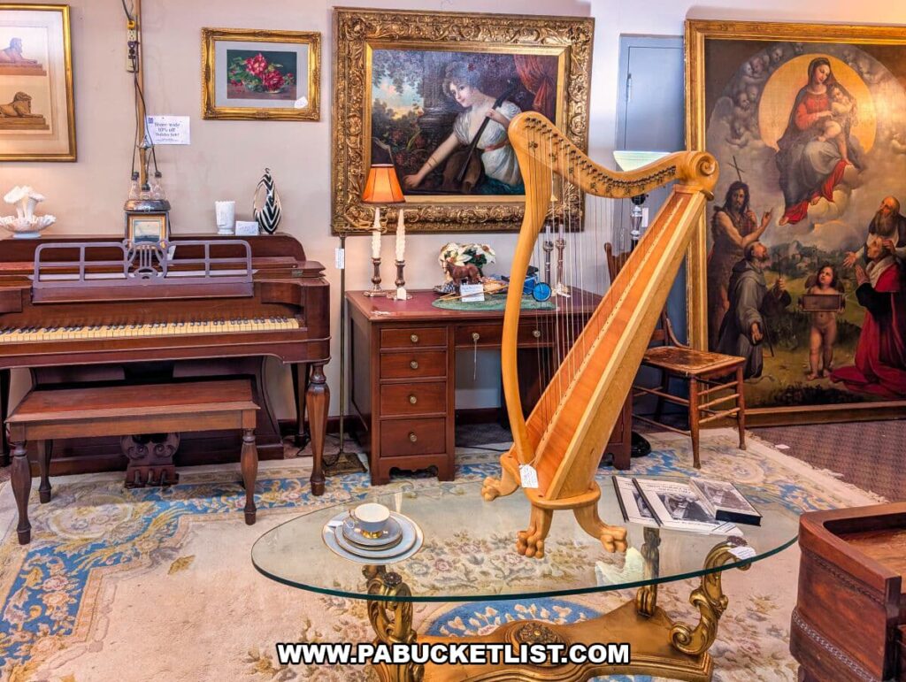 Curated antique display at Zelma’s Emporium featuring a vintage harp, upright piano, ornate framed artwork, antique desk, and decorative furnishings arranged like a period room inside the two-story antique mall in Adams County, Pennsylvania.