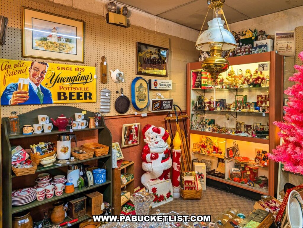 Vendor booth at Zelma’s Emporium featuring vintage advertising signs, holiday decorations, antique lamps, glass display cases filled with collectibles, and Americana decor arranged in a nostalgic display inside the two-story antique mall in Adams County, Pennsylvania.