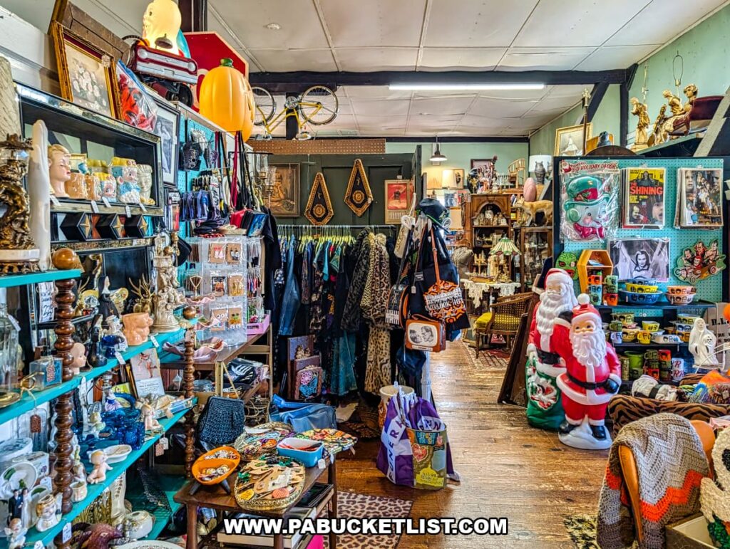 Interior view of American Daydream Antiques in York County, Pennsylvania, showing a narrow aisle packed with multi-vendor displays of vintage clothing, horror collectibles, vinyl records, VHS tapes, retro toys, holiday decor, advertising pieces, and eclectic antiques on wooden floors and colorful shelving