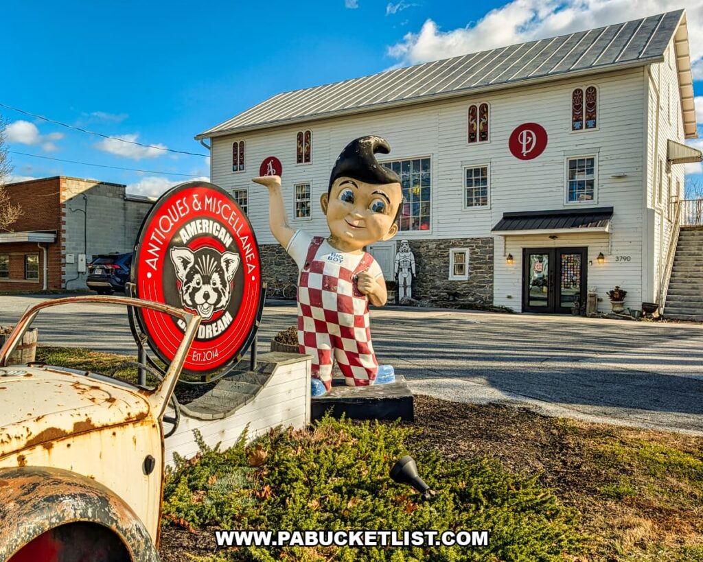 Exterior view of American Daydream Antiques in York County, Pennsylvania, featuring a large retro Big Boy statue and vintage sign in front of a two-story white building that houses a multi-vendor antique store known for vinyl records, comics, vintage toys, advertising memorabilia, and pop culture collectibles