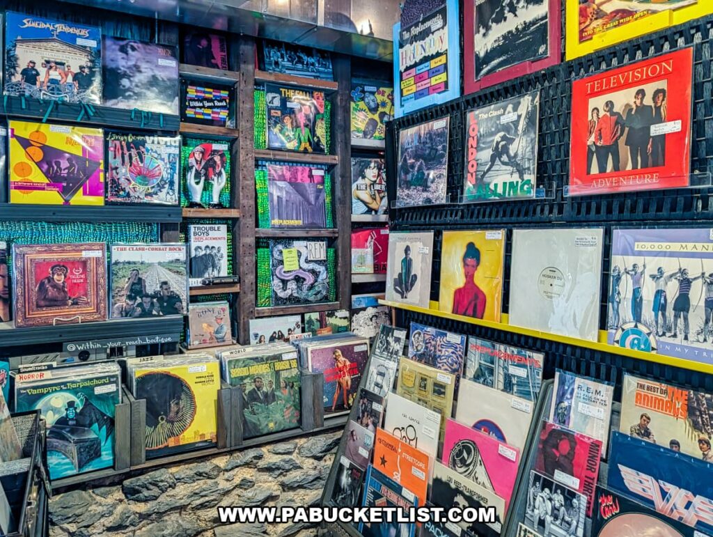 Vinyl record section inside American Daydream Antiques in York County, Pennsylvania, featuring wall-mounted and bin displays of vintage albums spanning punk, rock, new wave, alternative, jazz, and classic artists in a multi-vendor antique store