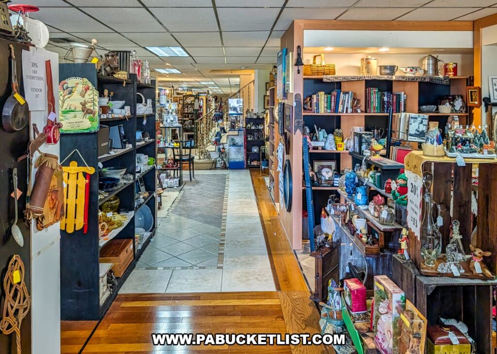 Interior view of an aisle inside Dover Antique Mall in York County, Pennsylvania, lined with tightly packed vendor booths displaying vintage books, glassware, collectibles, kitchenware, toys, and rustic décor, highlighting the crowded, eclectic atmosphere of a large multi-vendor antique mall.