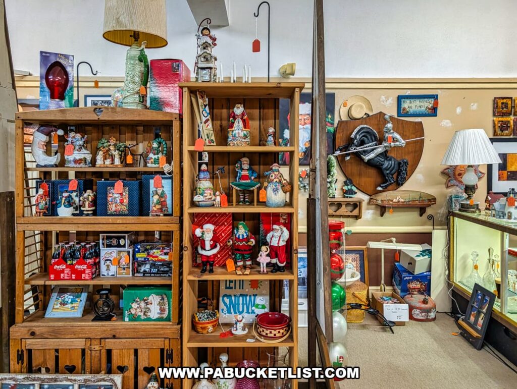 Shelves filled with vintage holiday decorations and collectibles at Grey Beards Antiques in York County, Pennsylvania, featuring Santa figurines, seasonal signs, glass ornaments, lamps, and nostalgic decor displayed within a vendor booth at the multi-vendor antique mall in Jacobus.
