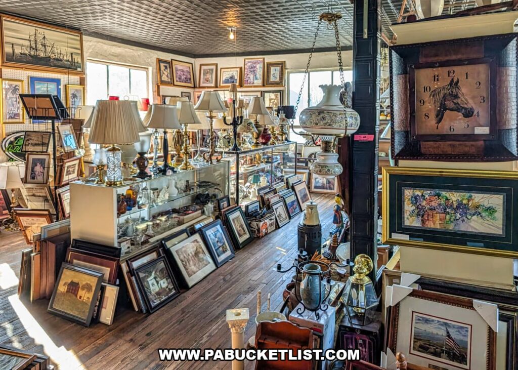 Interior view of Grey Beards Antiques in York County, Pennsylvania, showing aisles lined with vintage lamps, framed artwork, clocks, glass display cases, and decorative collectibles inside the multi-vendor antique mall in Jacobus.