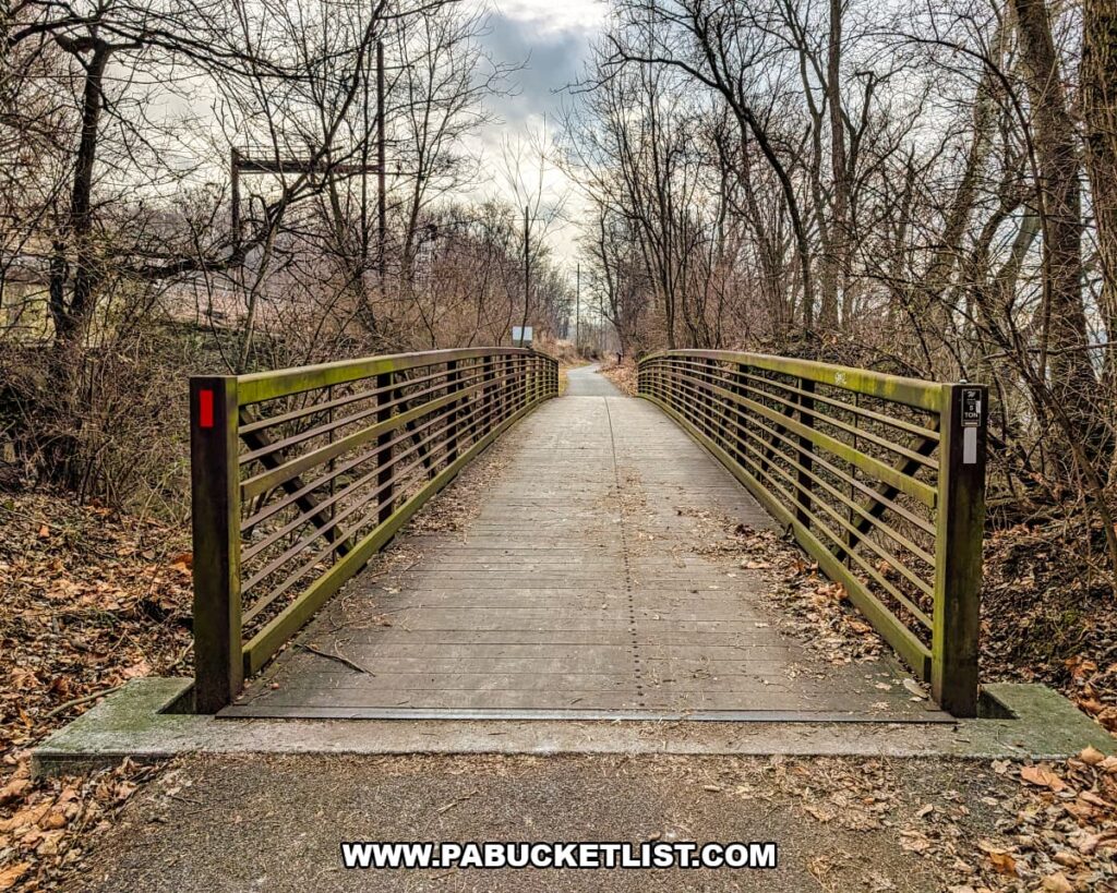 Pedestrian bridge along the Northwest Lancaster County River Trail crossing Conoy Creek, surrounded by leafless woodland near the White Cliffs of Conoy in Lancaster County, Pennsylvania.