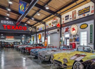 Row of classic Chevrolet Corvettes on display inside Barry’s Car Barn in Lancaster County, Pennsylvania, surrounded by vintage Texaco, Mobil, and Goodyear automotive signs in a spacious showroom.