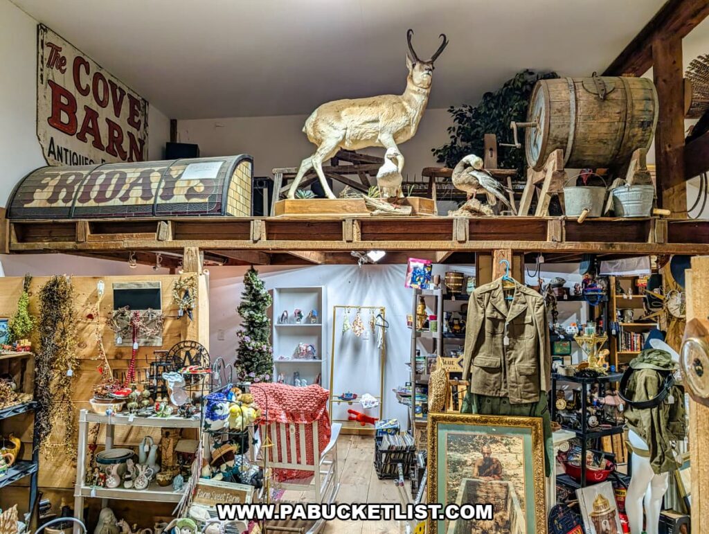 Interior scene at Cove Barn Antiques in Duncannon, Pennsylvania, featuring vintage signs, taxidermy displays, rustic barrels, clothing, and assorted collectibles arranged across a multi-level barn display