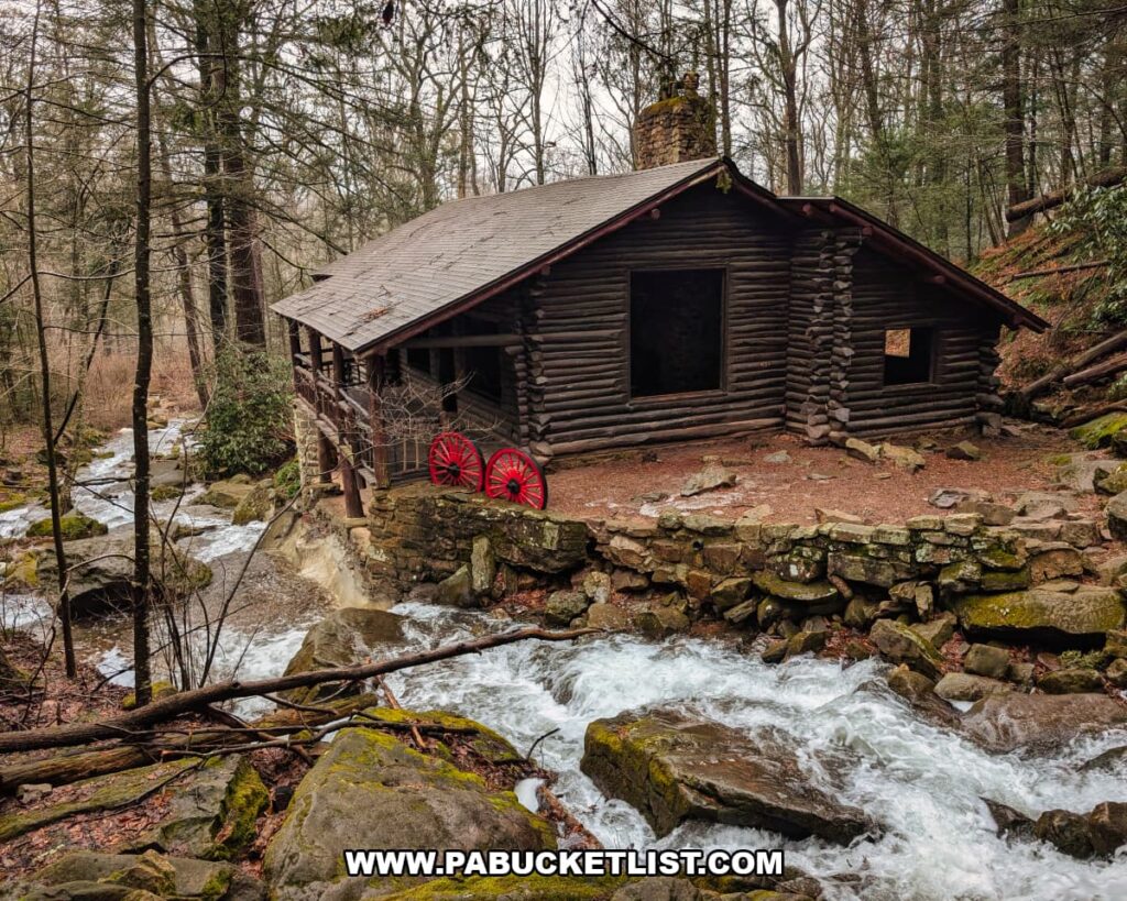 Bordner Cabin overlooking Rattling Run near Acrigg’s Falls in Swatara State Park, Lebanon County, Pennsylvania, showing the historic log cabin perched beside the rushing stream in a wooded setting.