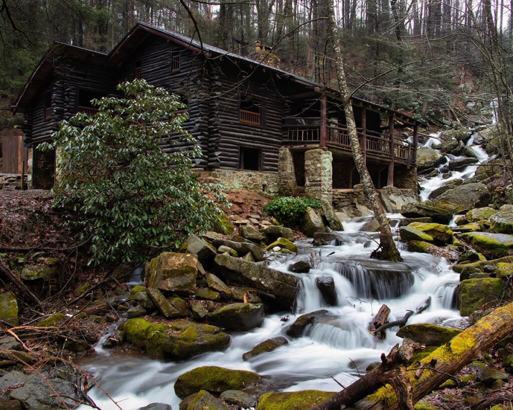 Bordner Cabin overlooking cascading water along Rattling Run at Acrigg’s Falls in Swatara State Park, Lebanon County, Pennsylvania, surrounded by moss-covered rocks and forest.