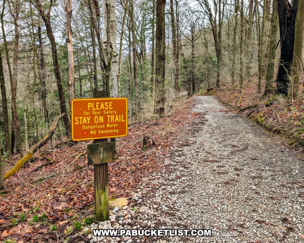 Safety sign advising hikers to stay on the Kildoo Trail due to dangerous water at McConnells Mill State Park in Lawrence County, Pennsylvania.