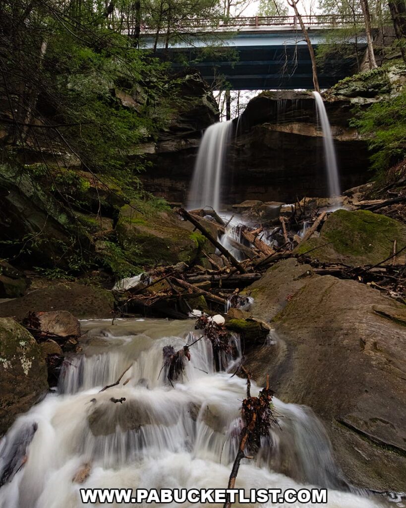 Kildoo Falls dropping over layered rock ledges beneath the road bridge at McConnells Mill State Park in Lawrence County, Pennsylvania.
