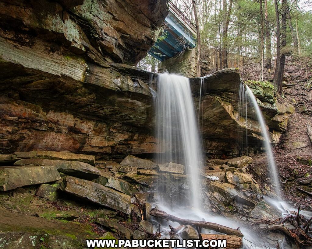 Front-facing view of Kildoo Falls cascading over a sandstone ledge beneath a bridge at McConnells Mill State Park in Lawrence County, Pennsylvania.
