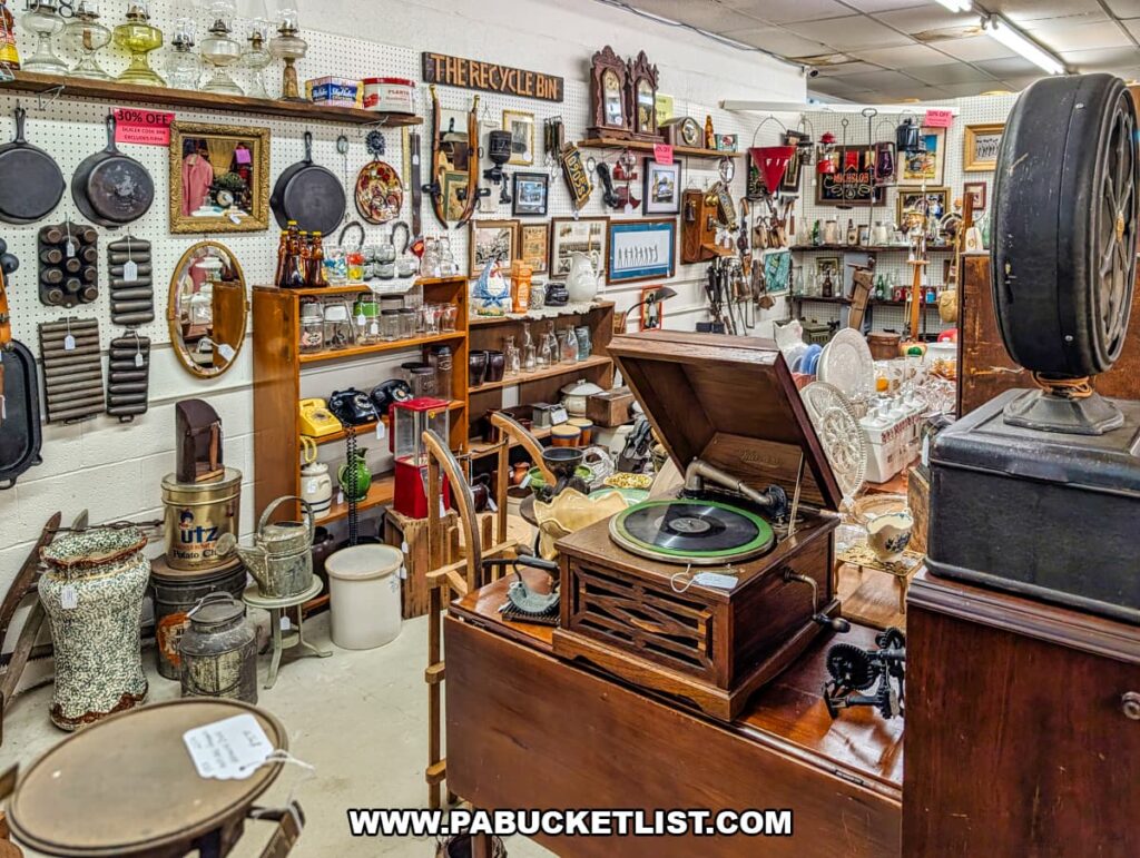 Antique phonograph surrounded by vintage kitchenware, tools, and collectibles inside Fayetteville Antique & Craft Mall in Franklin County, Pennsylvania.
