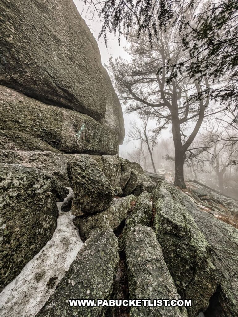 Close-up of the Pottsville conglomerate rock formation at Boxcar Rocks in Lebanon County, Pennsylvania, with fractured boulders and a foggy forest backdrop.