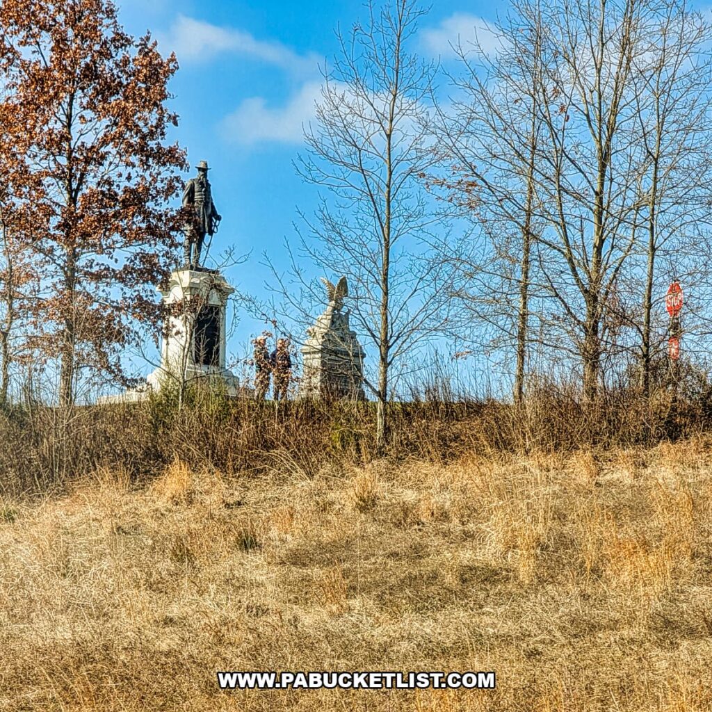 Union monuments on the Gettysburg Battlefield viewed through trees and winter grass from a Gettysburg Railway sightseeing train excursion in Gettysburg, Pennsylvania.