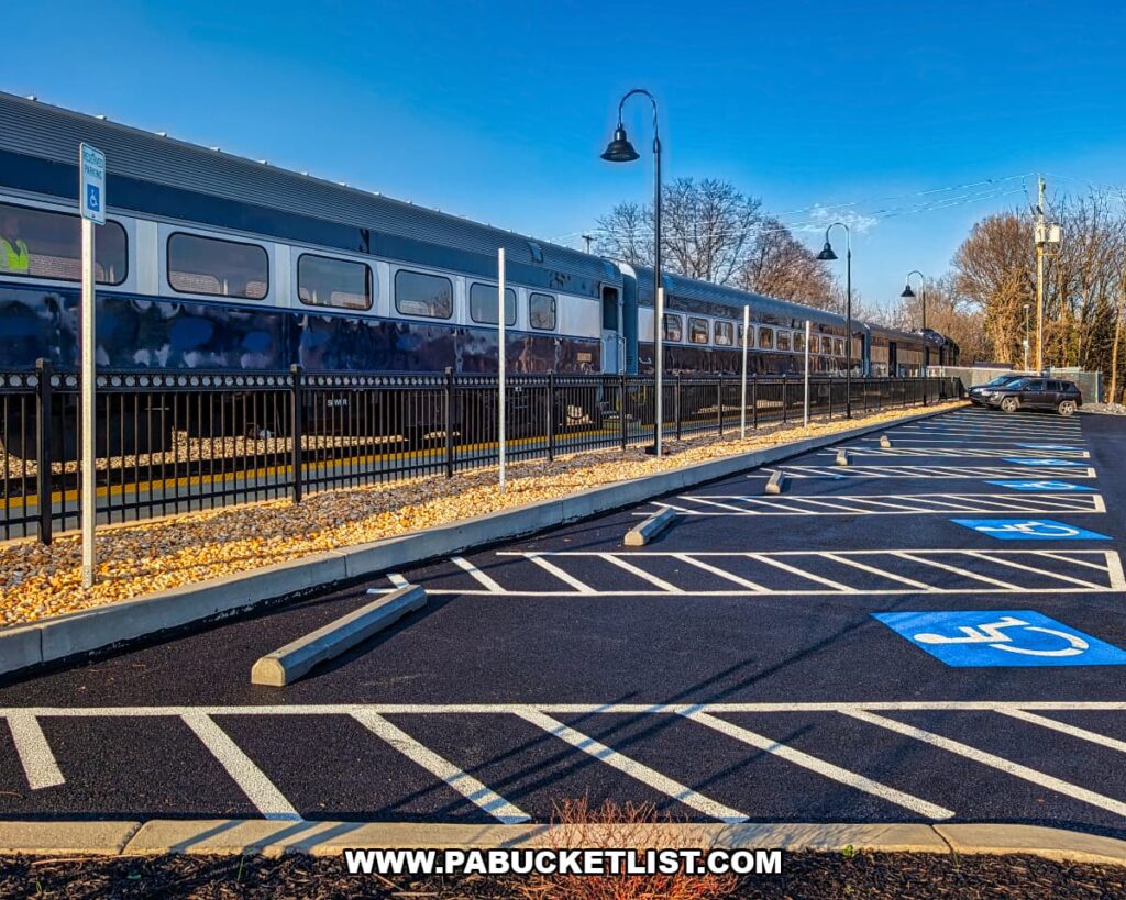 Gettysburg Railway sightseeing excursion train cars parked along the tracks beside the Gettysburg station and parking area in Gettysburg, Pennsylvania.