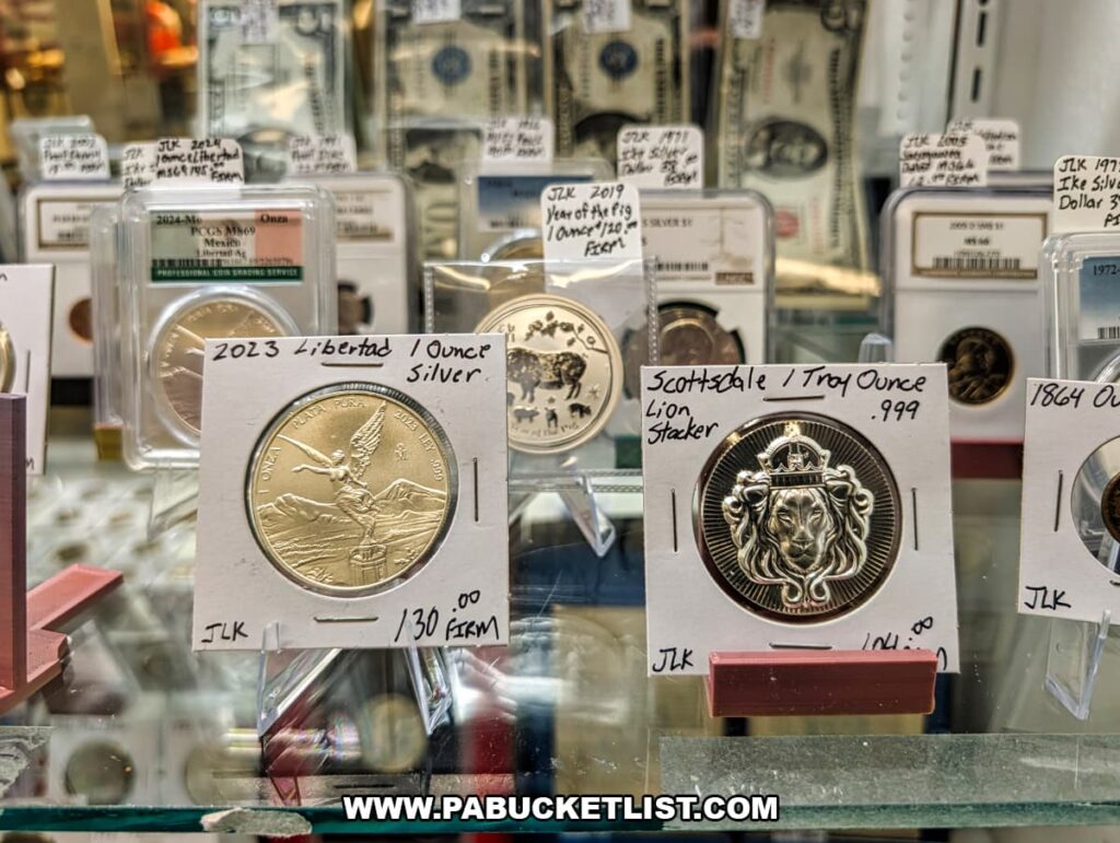 Display case with collectible silver coins and vintage currency for sale at Fayetteville Antique & Craft Mall in Franklin County, Pennsylvania.
