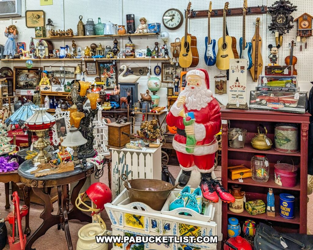 Vendor booth filled with vintage collectibles, guitars, lamps, toys, and a large Santa Claus figure at Fayetteville Antique & Craft Mall in Franklin County, Pennsylvania.