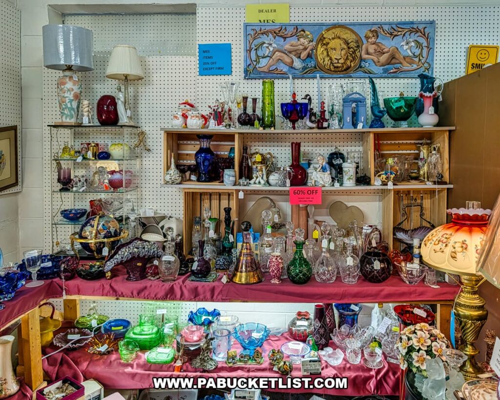 Colorful vintage glassware, decanters, and decorative glass pieces displayed in a vendor booth at Fayetteville Antique & Craft Mall in Franklin County, Pennsylvania.
