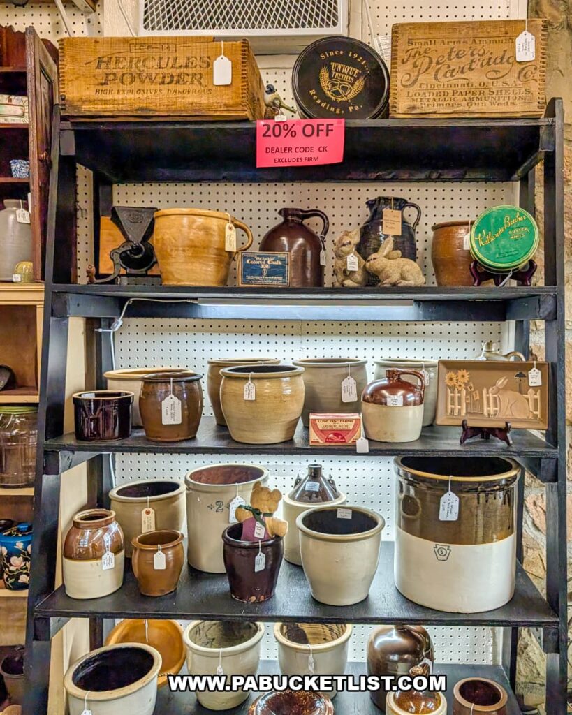 Display of vintage stoneware crocks, jugs, and pottery on shelves at Fayetteville Antique & Craft Mall in Franklin County, Pennsylvania.