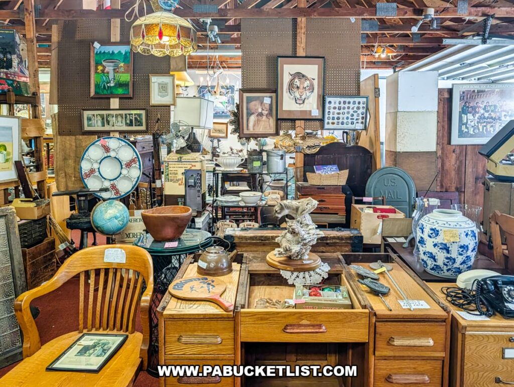 Dealer booth filled with vintage collectibles, furniture, artwork, and antiques inside Wagon Wheel Antiques in Butler County, Pennsylvania.