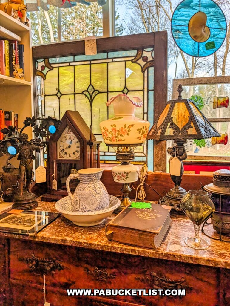 Antique display featuring stained glass, vintage lamps, pottery, and decorative pieces inside Wagon Wheel Antiques in Butler County, Pennsylvania.
