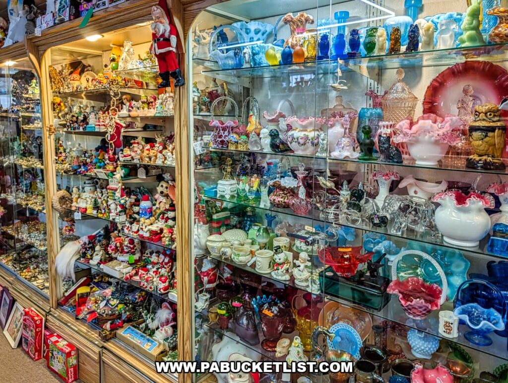 Glass display cases filled with vintage glassware figurines and collectibles inside Sugar Grove Antiques in Somerset County PA