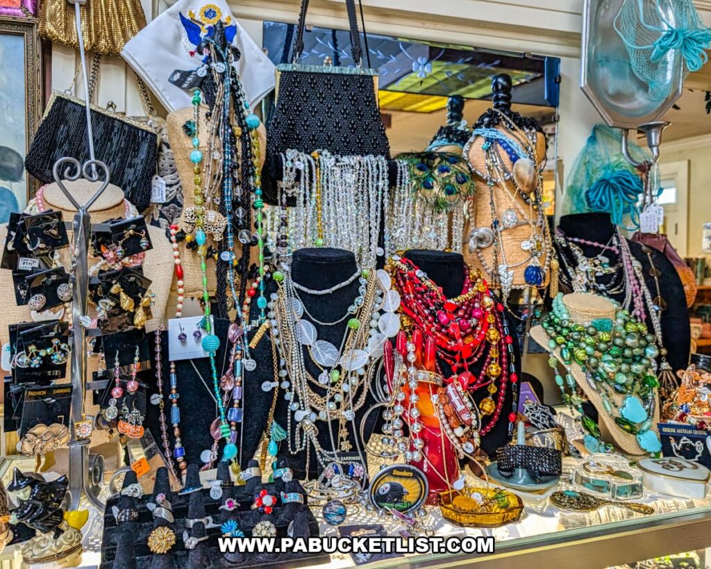 Display of vintage necklaces earrings and costume jewelry arranged on bust stands inside Sugar Grove Antiques in Somerset County PA