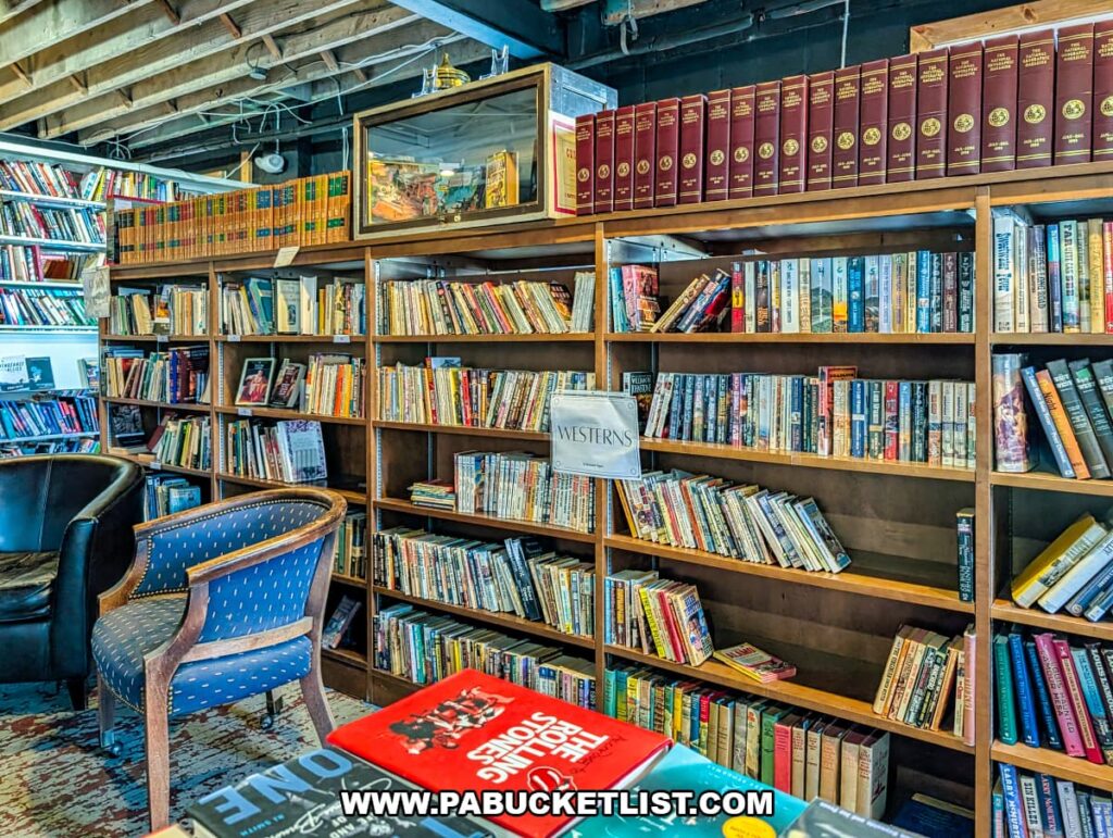 Shelves of used western novels and classic books at In Between Pages Bookstore in York PA with cozy chairs for browsing nearby