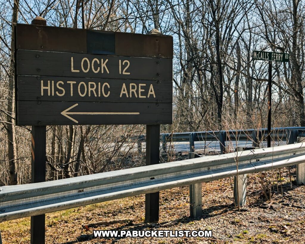 Wooden roadside sign pointing to the Lock 12 Historic Area along McCalls Ferry Road in York County, Pennsylvania.