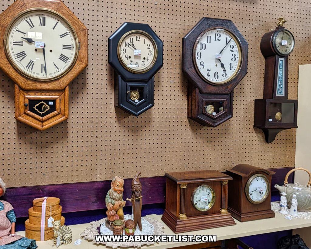 Collection of antique wall clocks and mantel clocks displayed at a vendor booth inside Pen-Mar Antique Market in Waynesboro Pennsylvania