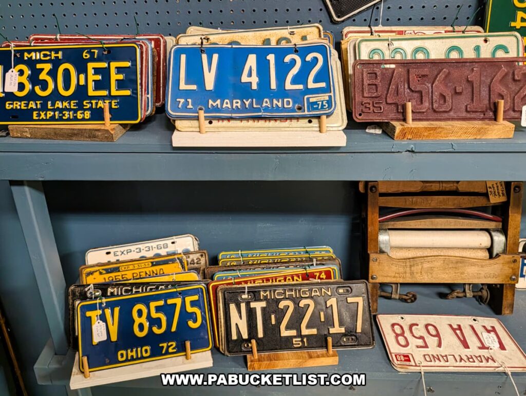 Collection of vintage license plates from various states displayed at a vendor booth inside Pen-Mar Antique Market in Waynesboro Pennsylvania