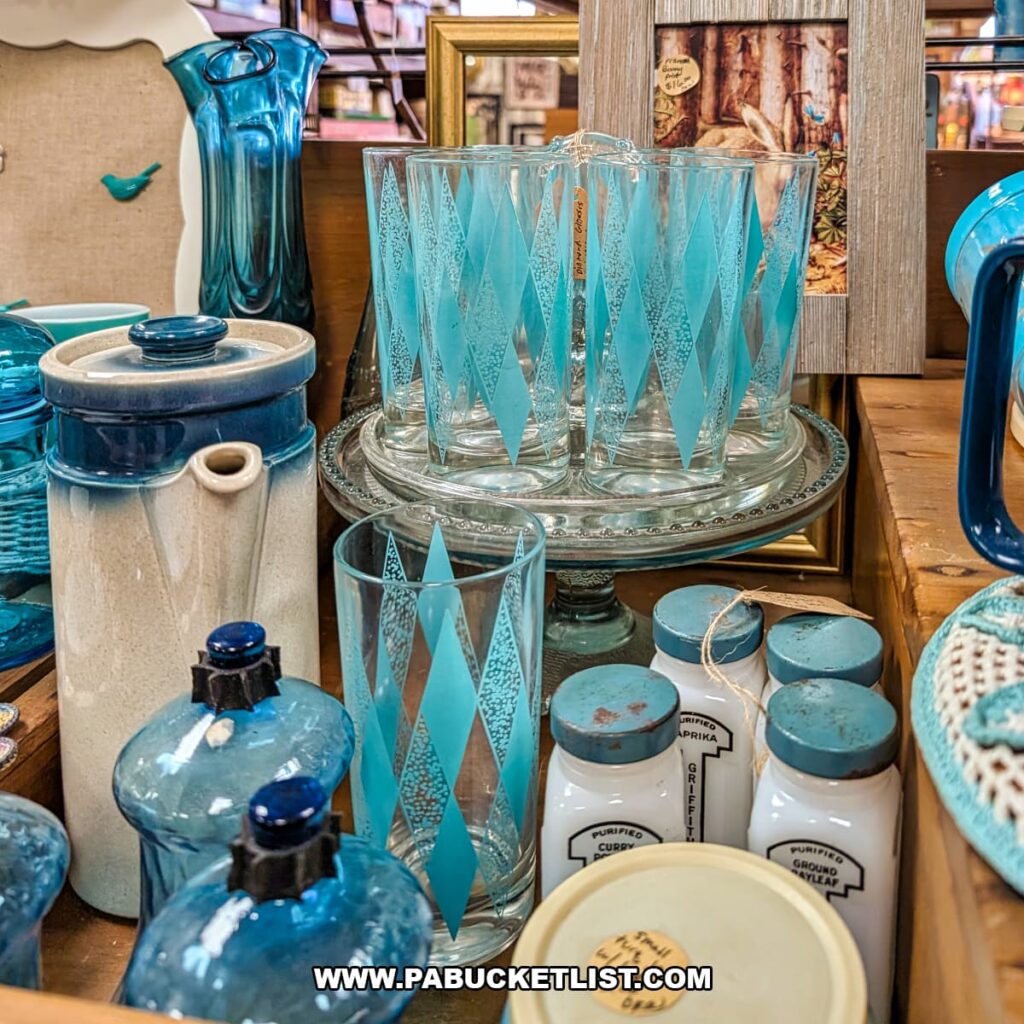 Display of vintage blue glassware, drinking glasses, and retro kitchenware at Treasure Bin Antiques in Red Lion, York County, Pennsylvania