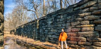 Visitor standing beside the stone walls inside Lock 12 of the historic Susquehanna and Tidewater Canal at the Lock 12 Historic Area in York County, Pennsylvania.
