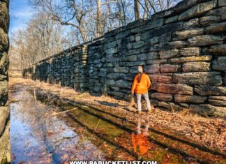 Visitor standing beside the stone walls inside Lock 12 of the historic Susquehanna and Tidewater Canal at the Lock 12 Historic Area in York County, Pennsylvania.