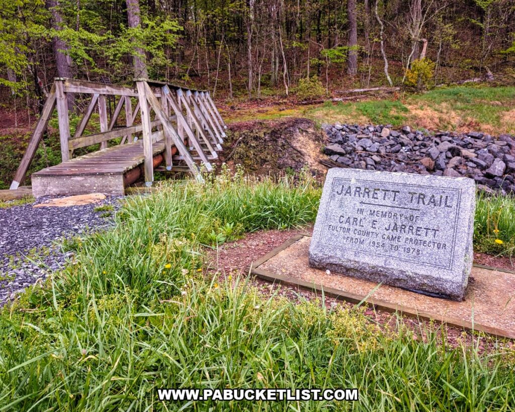 Jarrett Trail memorial marker and wooden footbridge near Jarrett Falls on State Game Lands 53 in Fulton County, Pennsylvania