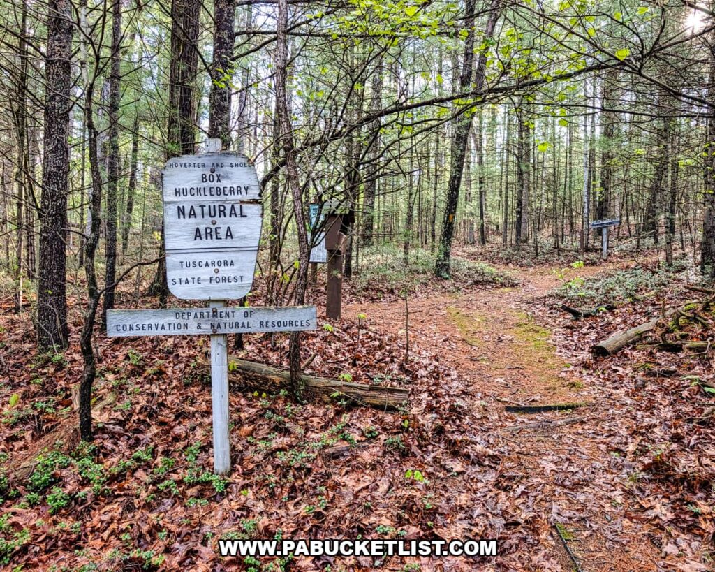 Trailhead sign for Hoverter and Sholl Box Huckleberry Natural Area along a forest path in Tuscarora State Forest Perry County Pennsylvania.