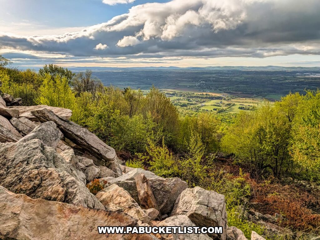 rocky overlook at waggoners gap hawk watch in perry county pennsylvania with expansive valley farmland and forest under dramatic spring clouds
